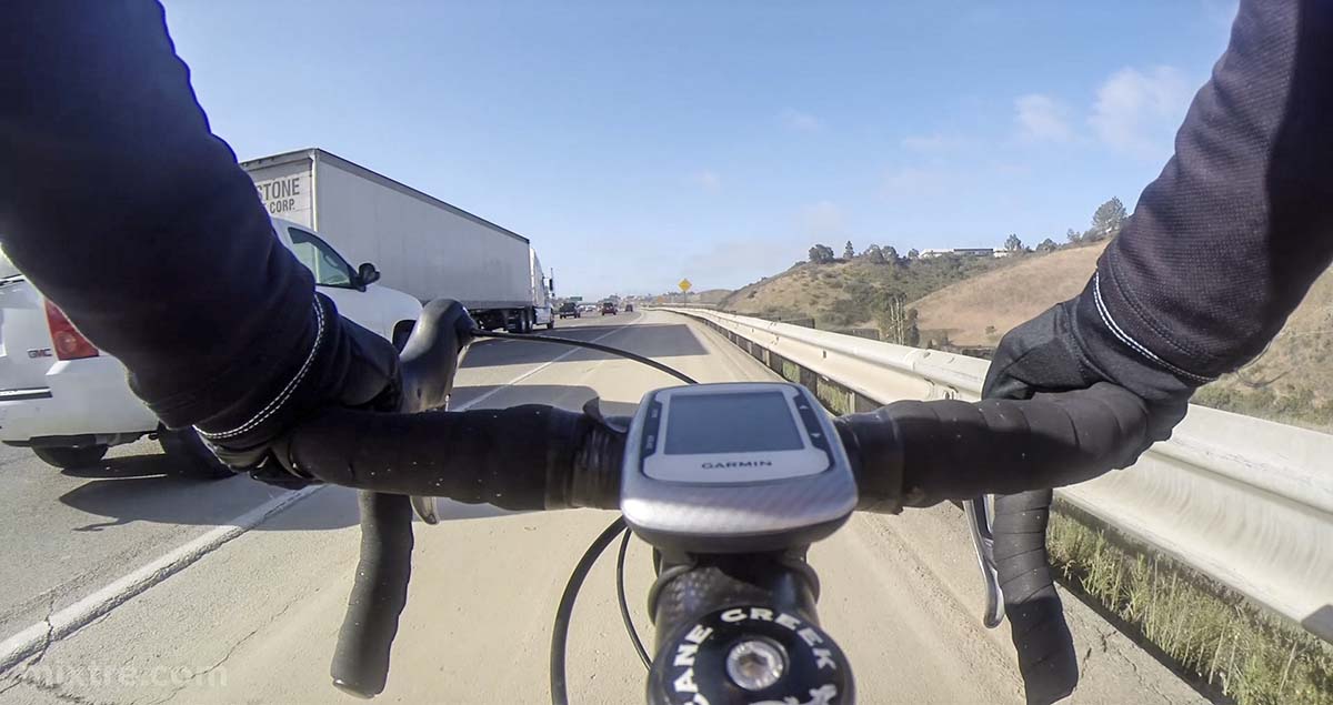 Riding a bicycle on the I-5freeway in San Diego in heavy traffic